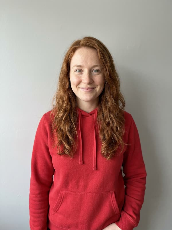 Photo: a woman with long red hair in a red hoodie