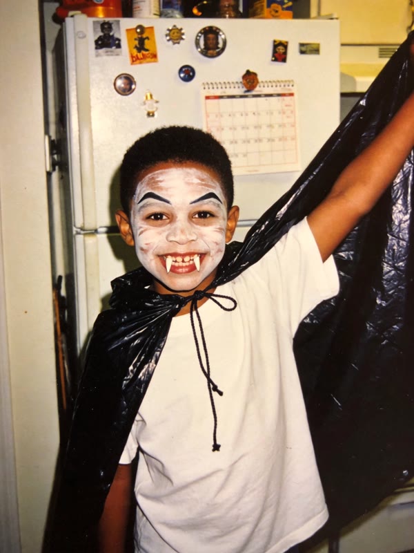 Real photo: trash-bag cape, white T-shirt and face paint